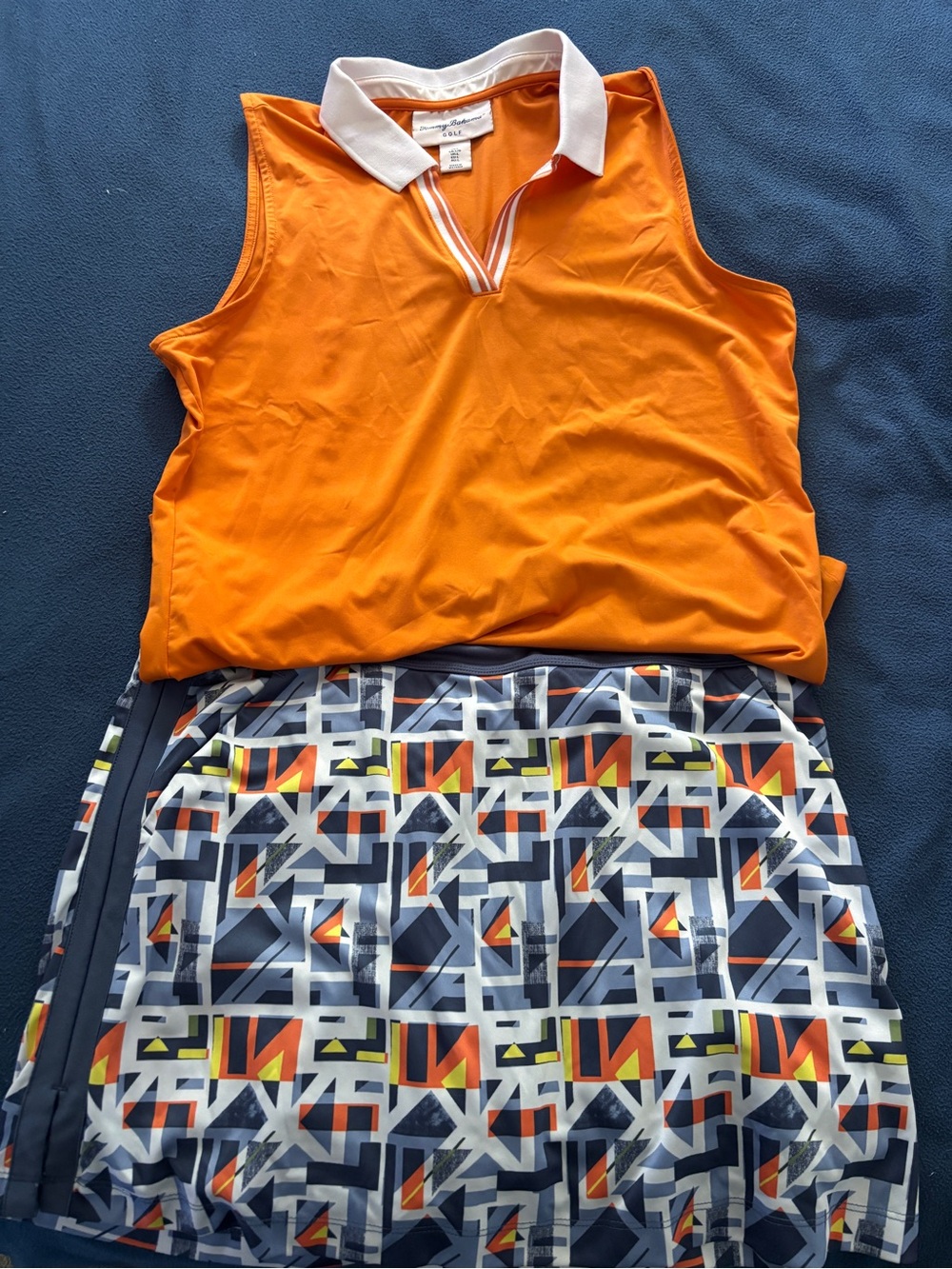 Tommy Bahama Orange Polo Golf Top with White Collar and Callaway golf skort